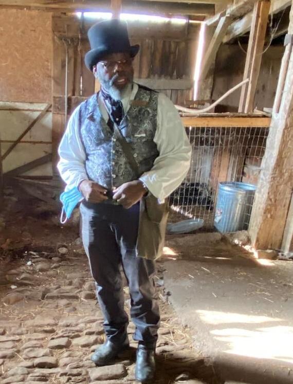 Kevin Cottrell, of Motherland Connextions, wears period clothing while conducting his tour of the Underground Railroad.jpg